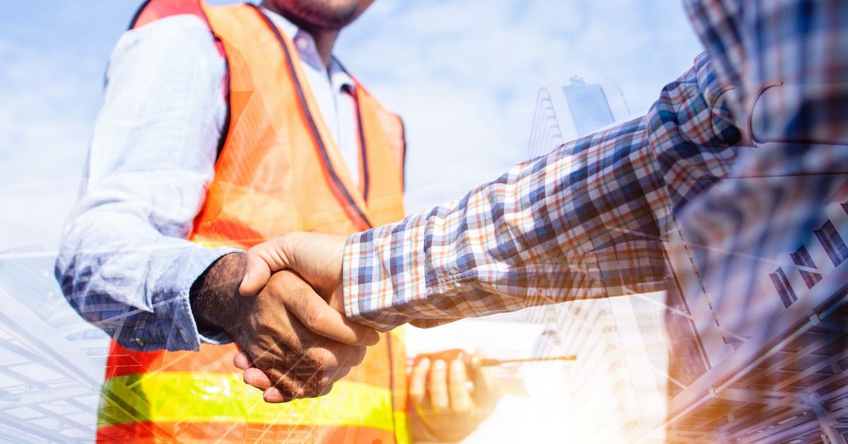 man shaking hands with construction worker